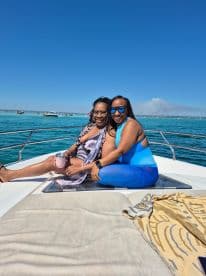 Two friends enjoy a sunny day on a boat, capturing the essence of friendship and fun on the water.