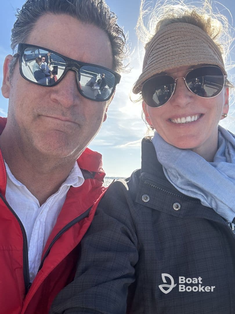 A couple enjoys a sunny day on the water, capturing a joyful selfie while boating — perfect for memorable adventures on the sea.