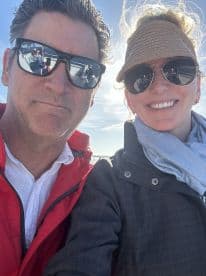 A couple enjoys a sunny day on the water, capturing a joyful selfie while boating — perfect for memorable adventures on the sea.
