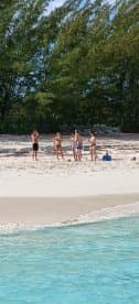A group of friends enjoys a sunny day at the beach, perfect for swimming and relaxation — an ideal setting for memorable summer adventures.