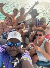 A lively group enjoys drinks and fun on a boat, capturing the essence of a perfect day at sea with friends.