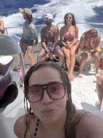 A lively group enjoys a fun day on the water, capturing the excitement of their boat trip with smiles and laughter.