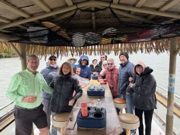 A cheerful group of friends gathers on a boat, enjoying drinks and each other's company — perfect for memorable outings and celebrations on the water.