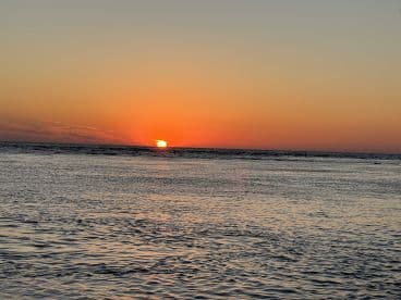 A stunning sunset over the ocean, creating a picturesque backdrop for evening boat adventures. Perfect for capturing the beauty of nature at sea.