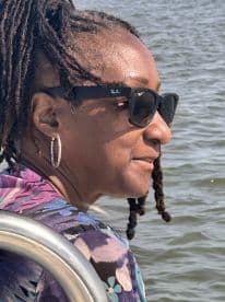 A woman enjoys a scenic boat ride, showcasing the relaxed atmosphere of a day on the water. Perfect for capturing memorable moments during a boating adventure.
