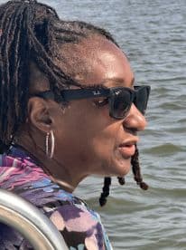A woman enjoys the serene views while on a boat, capturing the essence of relaxation on the water.