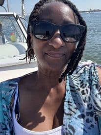 A joyful selfie taken on a boat, capturing the sunny day and beautiful water backdrop — perfect for showcasing fun moments on the water.