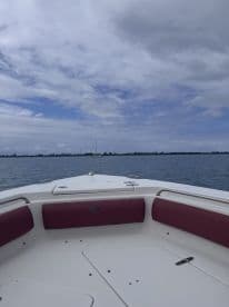 A view from the front of a boat showcasing the seating area and helm, perfect for enjoying a day on the water.