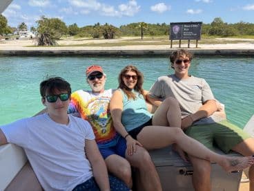 A cheerful group enjoys their time aboard a boat near Boca Chita Key in Biscayne National Park, perfect for family outings and adventures on the water.