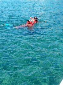 A couple enjoys snorkeling in crystal-clear waters, showcasing the beauty of underwater adventures and marine exploration.