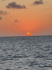 A stunning sunset over the ocean, creating a picturesque backdrop for evening boat cruises and tranquil moments on the water.