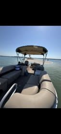 Interior view of a pontoon boat featuring spacious seating, perfect for relaxing and enjoying a day on the water.