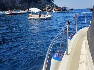 A vibrant scene of multiple boats enjoying a sunny day on the water, showcasing the fun and camaraderie of a boating adventure.