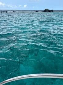 A view of clear turquoise waters with an island in the distance, but the image lacks clarity and focus.