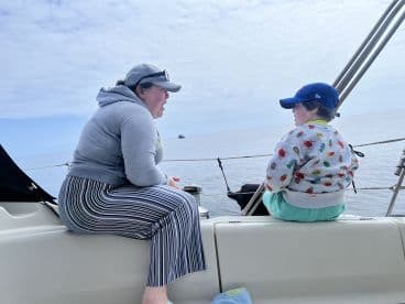 A mother and child share a moment on the boat, enjoying the serene waters and each other's company — a perfect snapshot of family bonding on the water.
