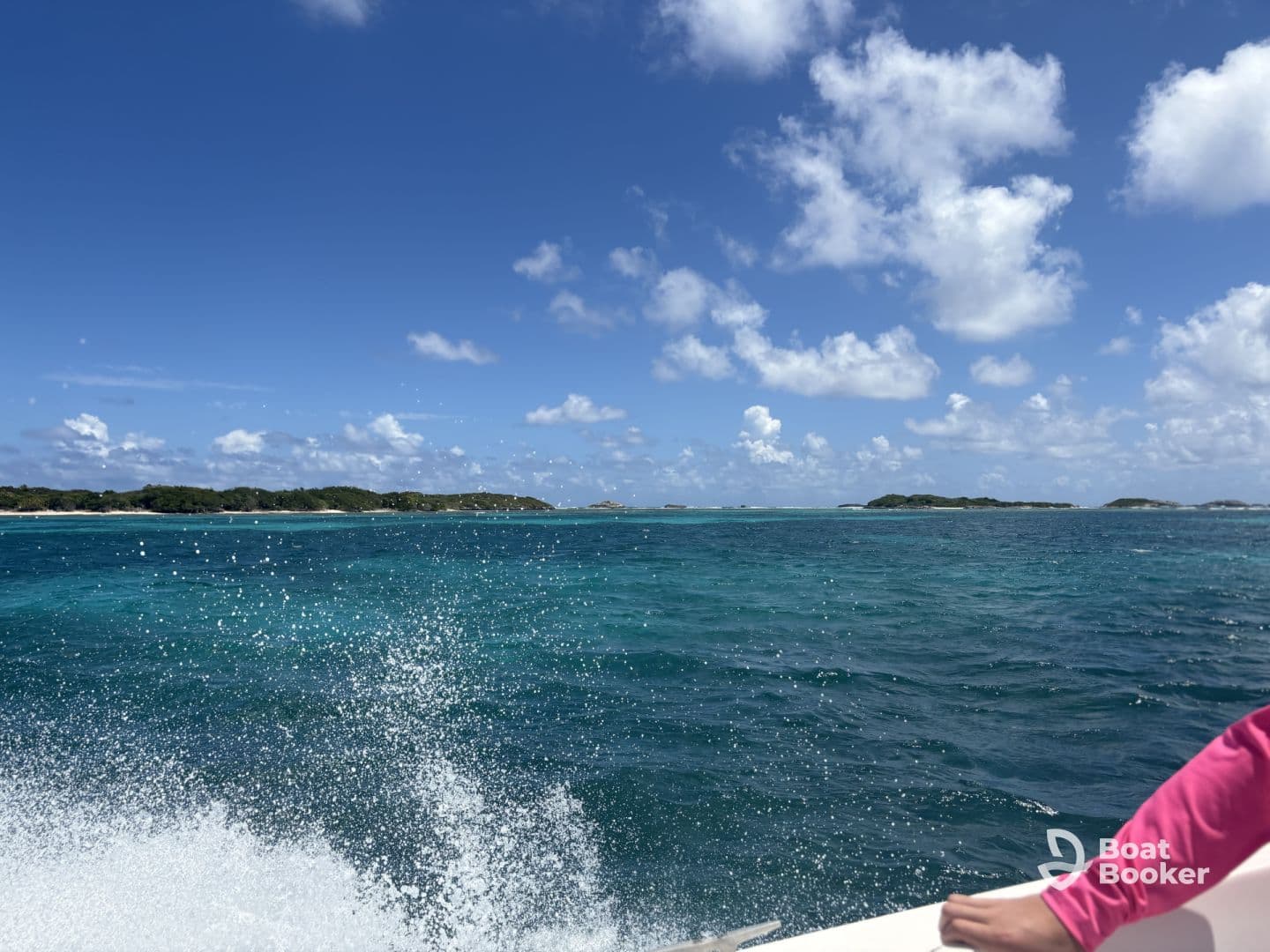 A stunning view of turquoise waters and distant islands, captured from a moving boat — perfect for showcasing the beauty of a day on the water.