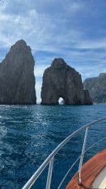A stunning view of iconic rock formations rising from the ocean, showcasing the natural beauty of the coastline — perfect for sightseeing tours.