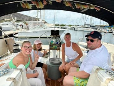 A cheerful family enjoys time aboard a boat, capturing fun moments together in a cozy interior setting — perfect for family outings on the water.