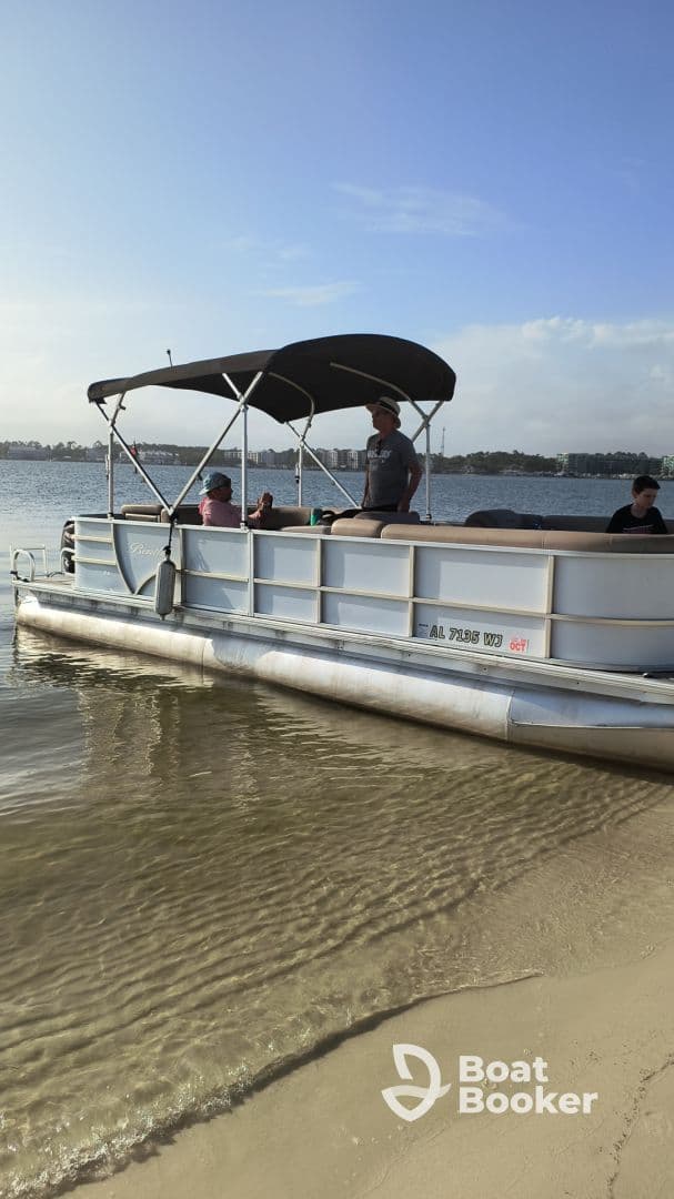 A group enjoys a relaxing day on a pontoon boat at the beach, perfect for family outings and fun in the sun.