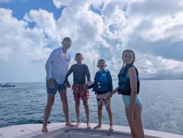 A joyful group of children enjoys a fun day on the boat, showcasing the excitement of ocean adventures and family bonding.