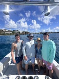 A cheerful group of family members poses on a boat, enjoying their time on the water — perfect for memorable outings and adventures.