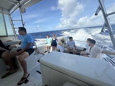 A lively group enjoys a boat ride on the ocean, capturing the essence of fun and adventure on the water.