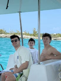 A group of friends enjoys a day on the water, capturing the essence of fun and camaraderie aboard a boat.