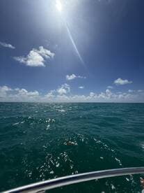 A scenic view of the ocean under a bright sky, but the image lacks clarity and focus.