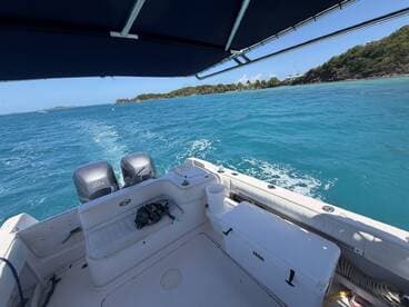 Interior view of a boat's helm and seating area, showcasing the clean and functional design ideal for a day on the water.