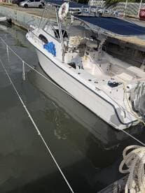 A sleek speedboat docked at the marina, showcasing its modern design and spacious interior, perfect for day trips on the water.