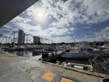 A scenic view of a marina filled with various boats under a bright sky, showcasing the vibrant boating lifestyle.