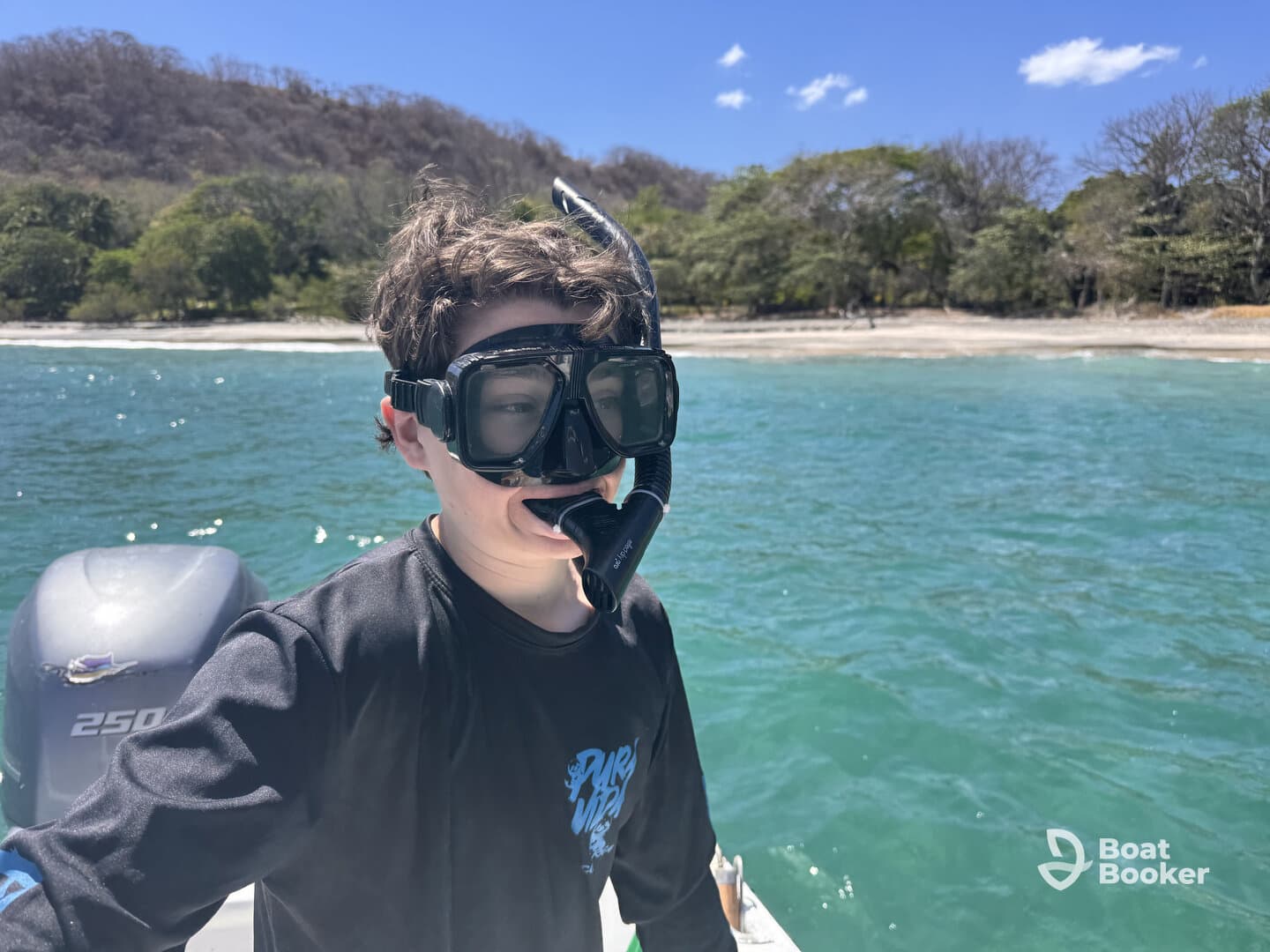 A young boy prepares for an exciting snorkeling adventure in clear blue waters, showcasing the thrill of exploring marine life.