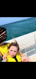 A young girl in a life jacket enjoys a fun day on the boat, showcasing the joy of family adventures on the water.