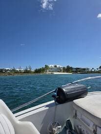 A scenic view from a boat showcasing a beautiful coastline and luxurious homes, perfect for capturing the essence of a day on the water.