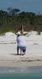 A romantic beach proposal captures a couple in a heartfelt moment, perfect for celebrating love and special occasions by the water.
