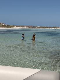 Two friends enjoy snorkeling in the clear waters of a beautiful beach, making for an unforgettable aquatic adventure.