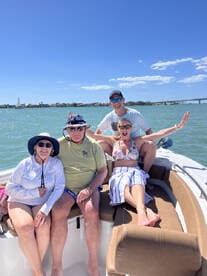 A cheerful group enjoys a sunny day on the boat, capturing fun moments together — perfect for family outings or friends' adventures on the water.
