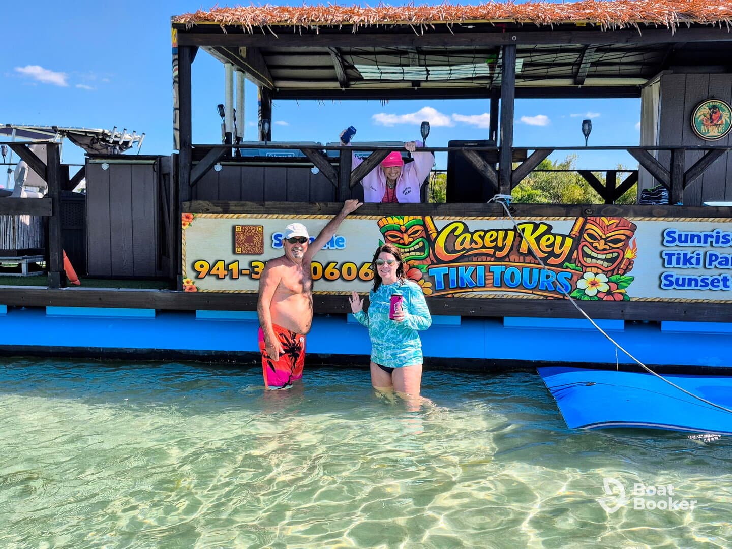 Guests enjoy a fun moment at Casey Key Tiki Tours, celebrating with drinks in shallow waters — a perfect spot for memorable outings on the water.