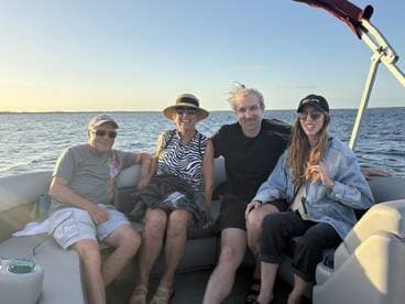 A cheerful group of friends enjoys a relaxing moment on a boat, capturing the essence of a perfect day on the water.