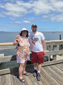 A cheerful moment captured at the dock with a family member, showcasing a beautiful day by the water.