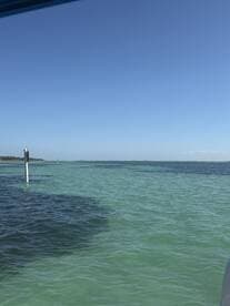 A view of turquoise waters with a distant shoreline, but the image lacks clarity and focus.