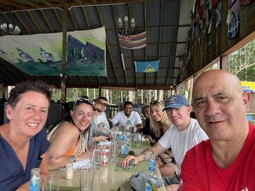 A lively group enjoys a meal together in a vibrant dining area, perfect for celebrating special moments during their boating adventure.
