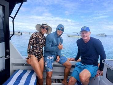 A cheerful group of friends enjoys their time aboard a boat, showcasing the fun and camaraderie of a day on the water.