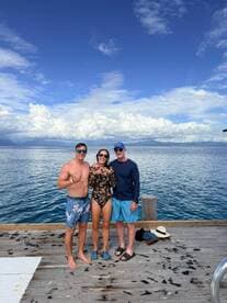 A cheerful group poses for a photo on the dock, showcasing a fun day by the water — perfect for memorable moments during a boating adventure.