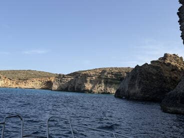A stunning view of rocky cliffs and clear waters, showcasing the natural beauty of the coastline — perfect for exploring hidden coves and enjoying scenic boat trips.
