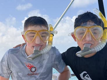 Two young snorkelers pose with their gear, ready for an underwater adventure — perfect for family outings and marine exploration.