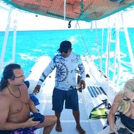 Guests prepare for snorkeling on a boat surrounded by vibrant blue waters, showcasing the excitement of marine adventures.