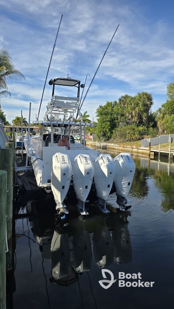 A sleek motorboat docked with multiple outboard engines, showcasing its impressive design and functionality. Ideal for fishing or cruising adventures.