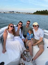 A joyful family enjoys a boat ride together, capturing a memorable moment on the water with smiles and laughter.