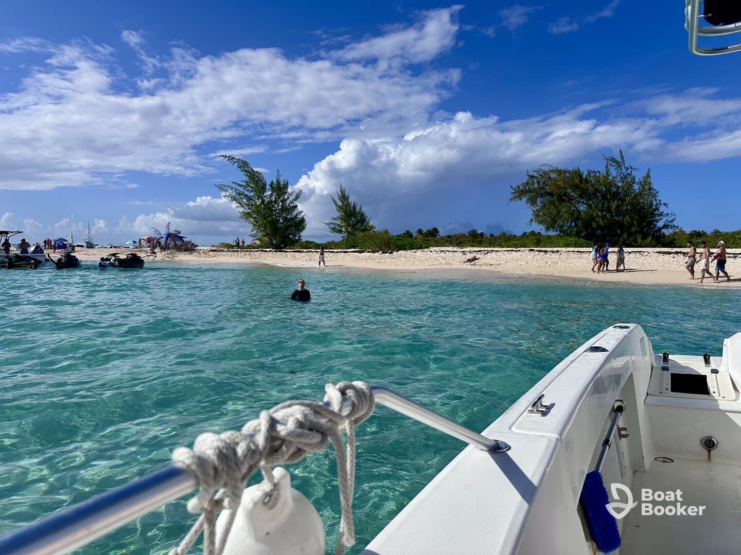 A vibrant scene at a sandbar with people enjoying the beach and swimming, while jet skis are anchored nearby — perfect for a fun day on the water.